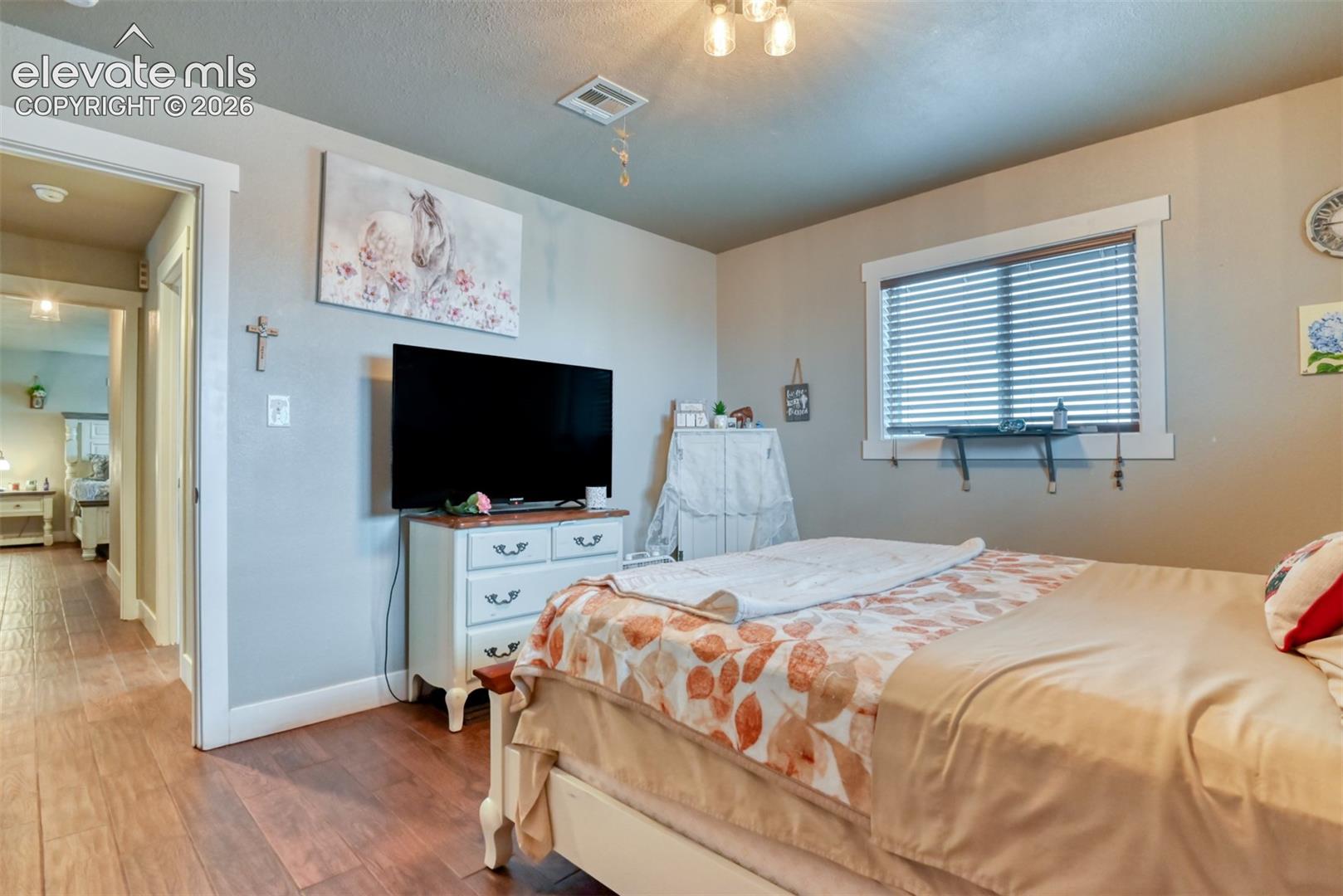 Bedroom with baseboards and wood finished floors