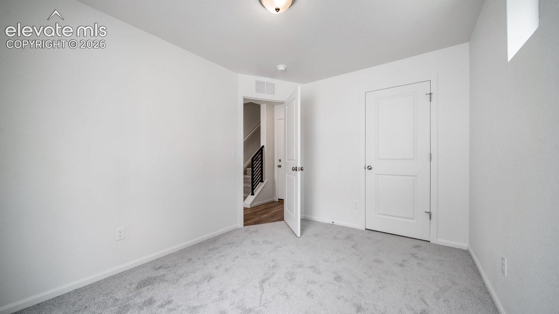 Plush gray carpeting throughout the room
*photos of a model home*
