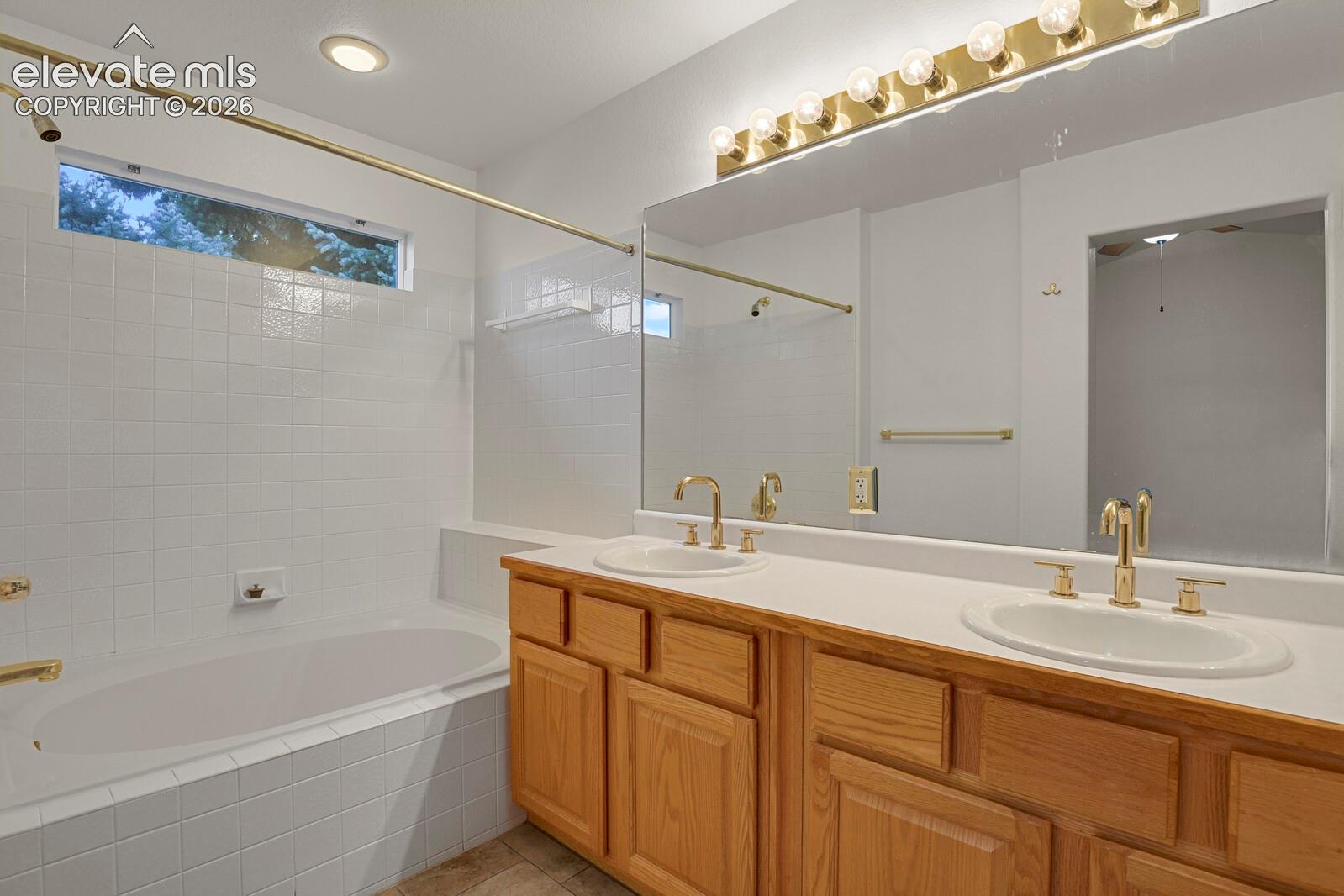 Dual vanity with brass-finish fixtures and integrated sinks