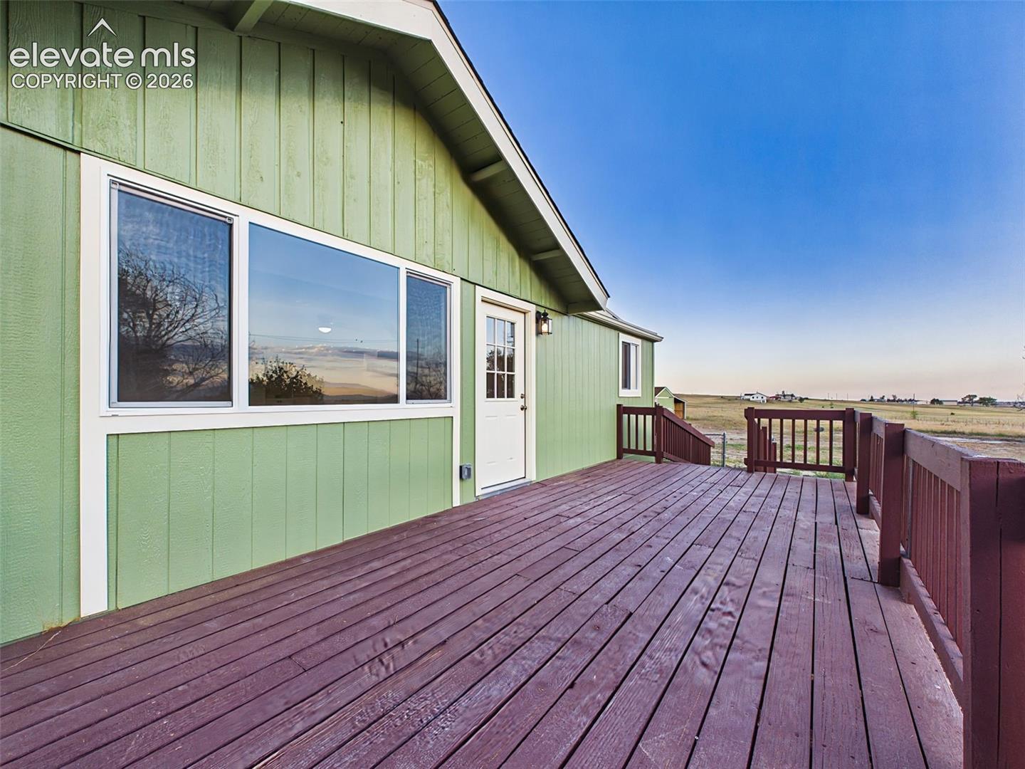 Large wood deck extends the home's living space outdoors with plenty of room for entertaining or gathering with family and friends.