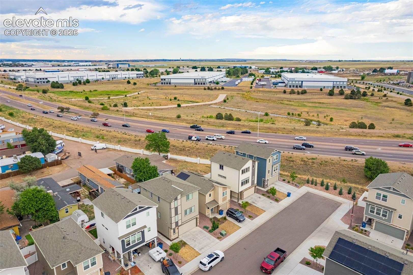 Aerial perspective showcasing multiple contemporary residential properties and surrounding infrastructure