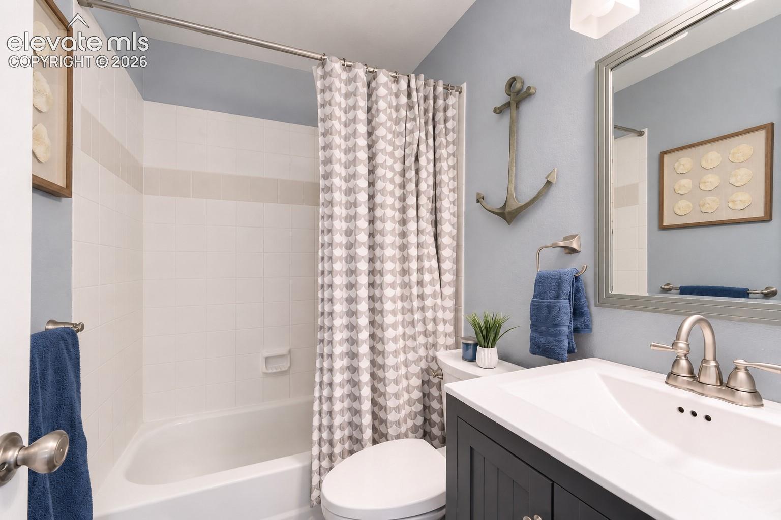 Basement bathroom has a tub/shower, neutral colors.