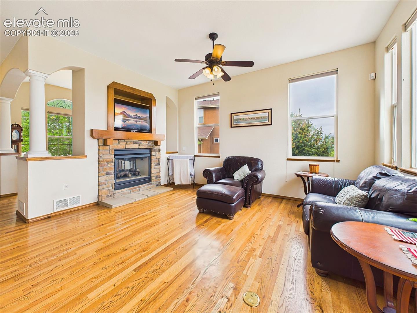 Spacious main living area with hardwood flooring, architectural columns, and an open flow ideal for everyday living and entertaining.