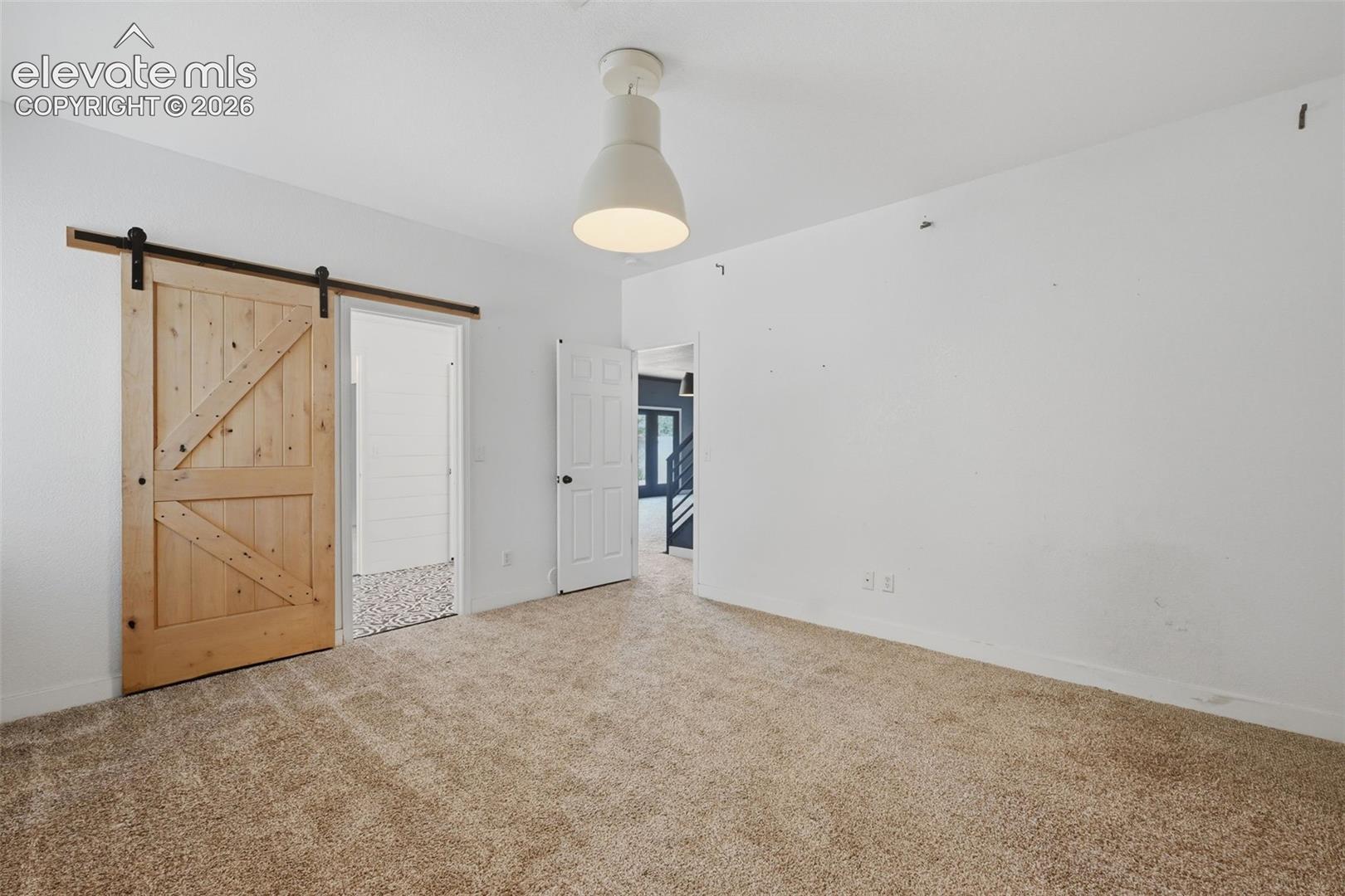 Bedroom #6 with barn door to the jack-n-jill bath and walk in closet!