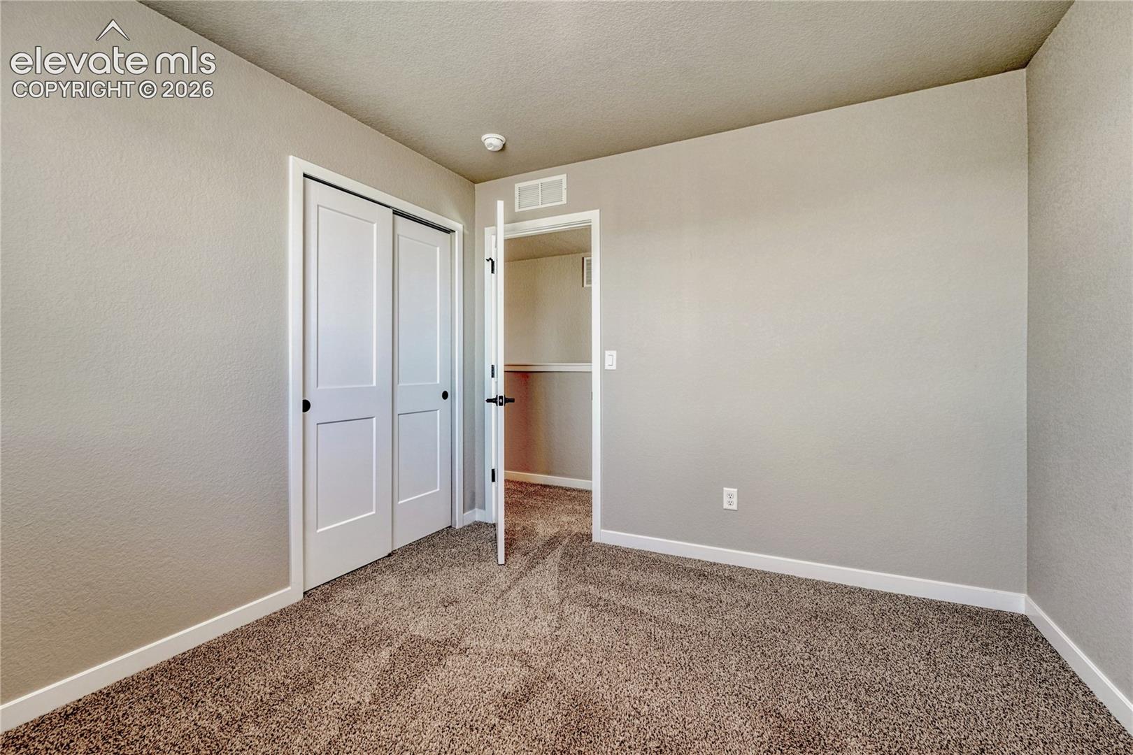 Second of three additional upstairs bedrooms. 