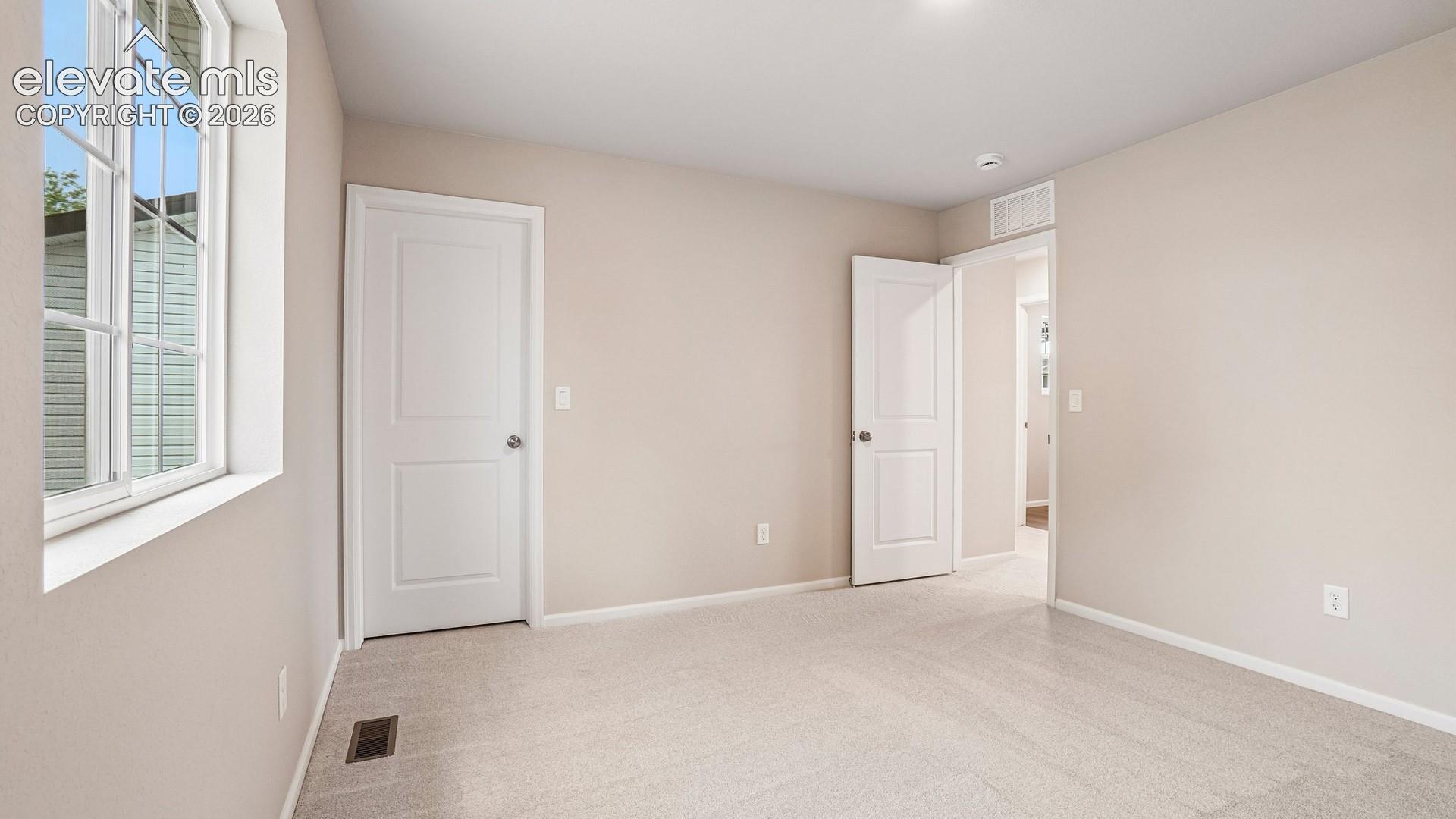 Carpeted flooring, neutral wall tones, white trim, and white paneled doors
*photos of a model home*