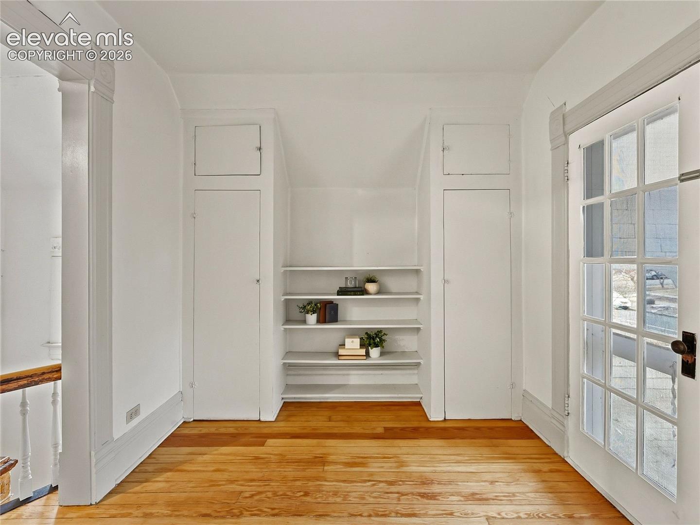 Primary sitting room w/french doors, built-ins, opening to balcony.