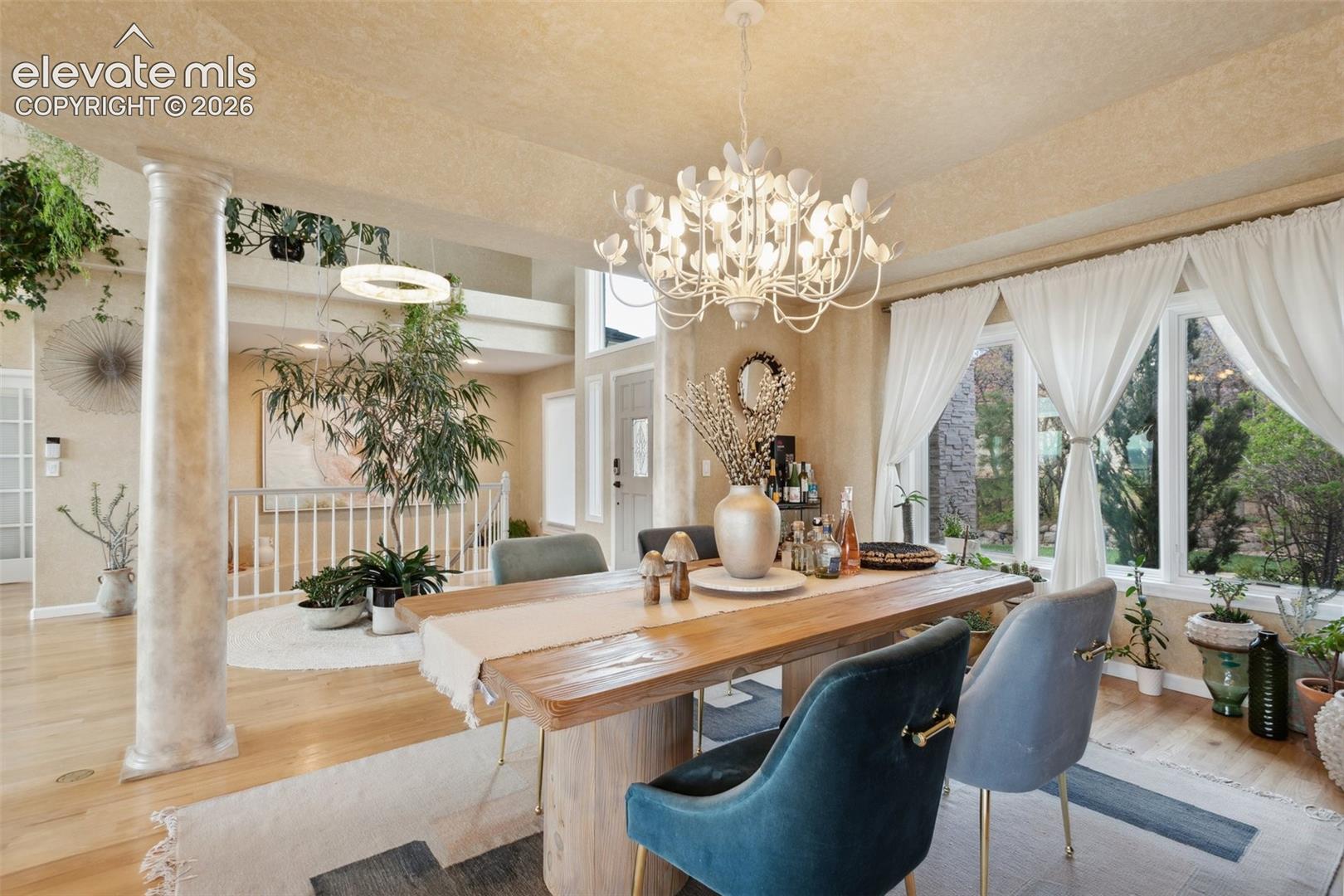 Dining area featuring a substantial wood table and a distinctive chandelier