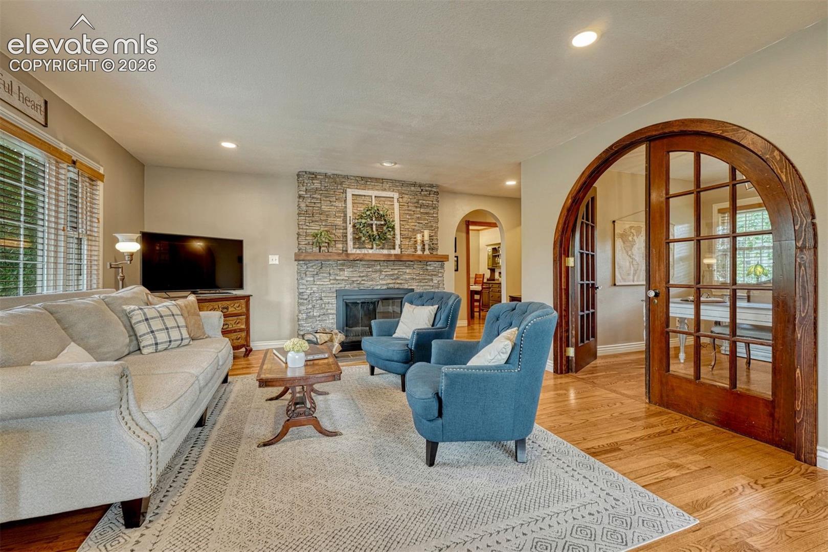 Inviting great room with a wood-burning stone fireplace.