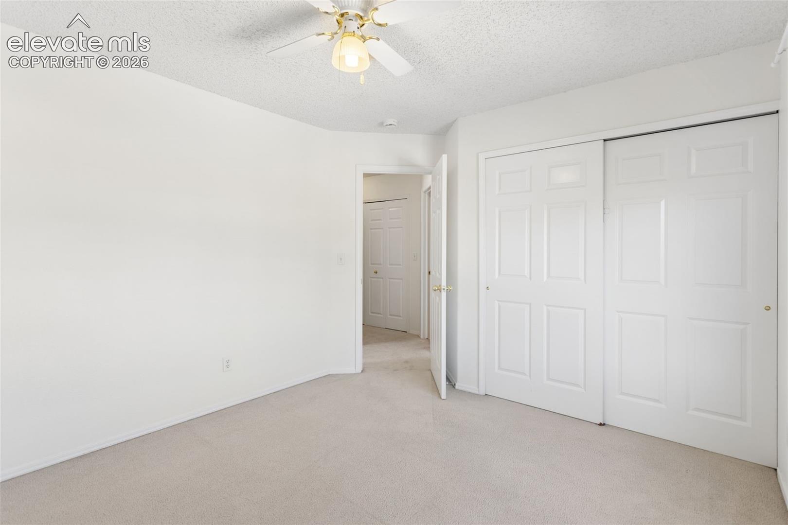 Upstairs bedroom facing north. Looking into hallway you can see the laundry area doors.