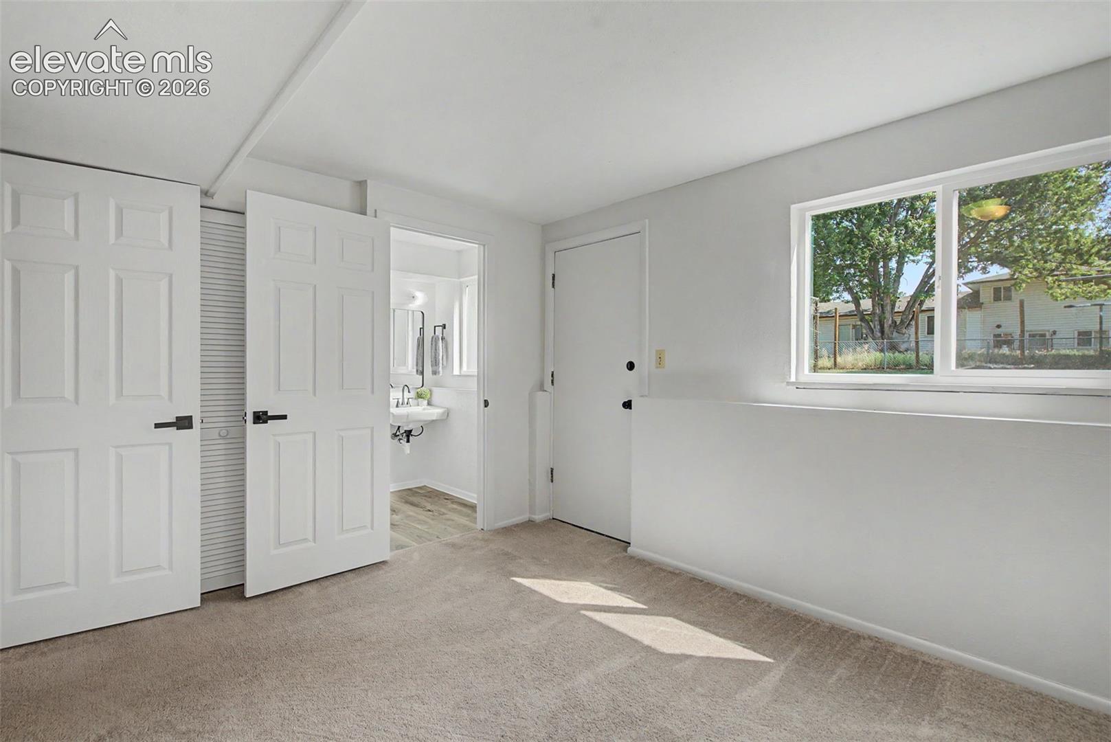 lower bedroom, attached 1/2 bath, walk-out to backyard