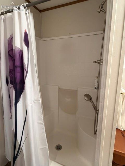 Oversized shower with two small benches.