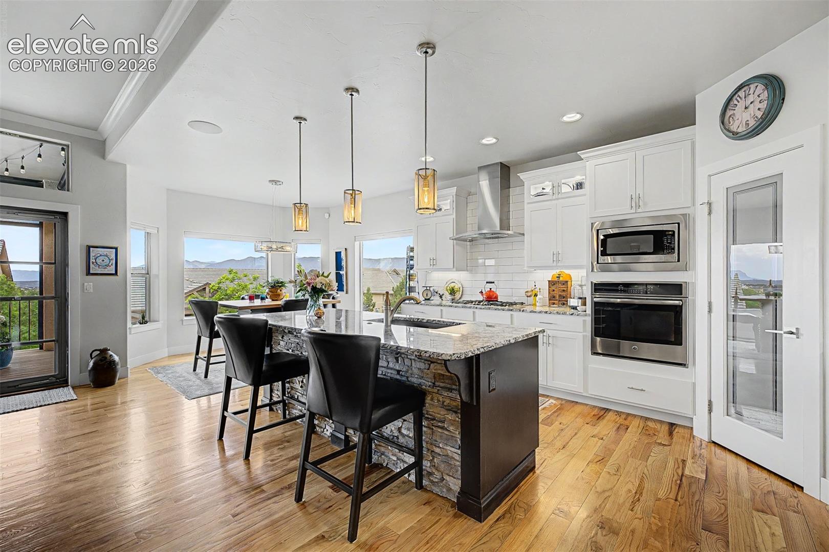 Open kitchen and dining area, with a walk out to a large, covered patio which makes for great entertaining.