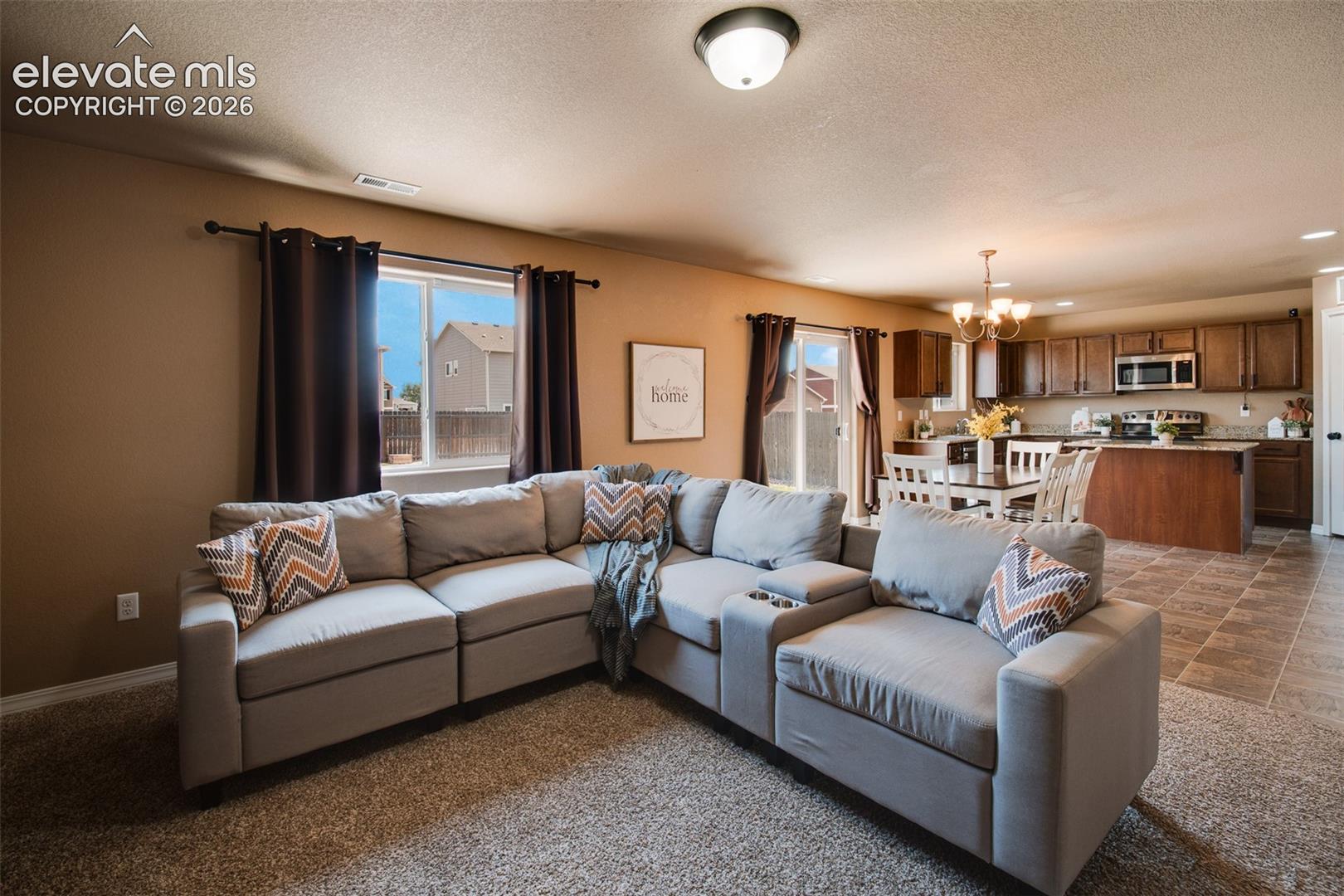 The bright & welcoming family room is filled with natural light & seamlessly connects to the dining area & kitchen.
