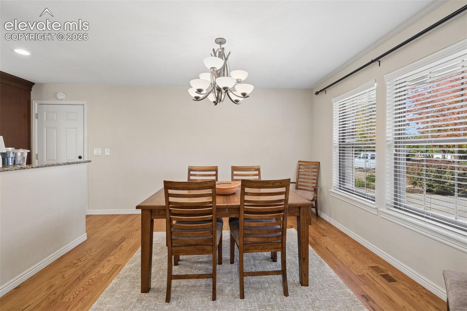 Separate dining area with wood floors and large windows 