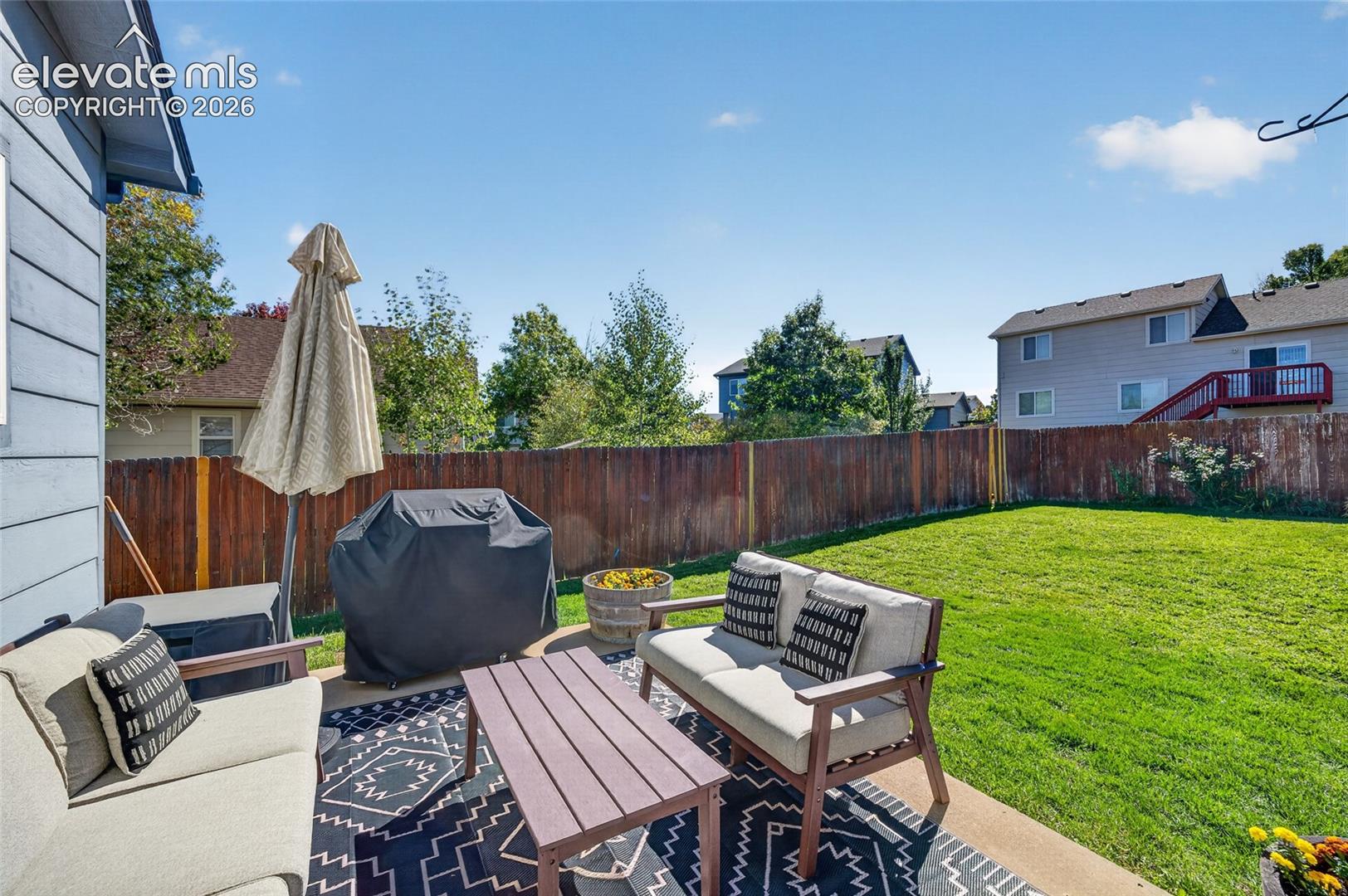 Back patio and fully fenced backyard