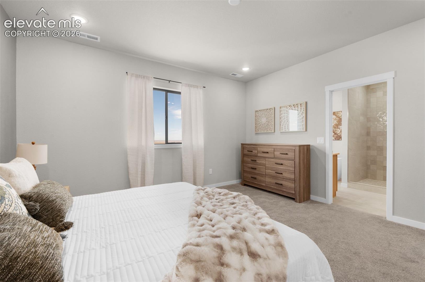 Recessed ceiling lighting, a framed window, light gray wall paint, and carpeted flooring