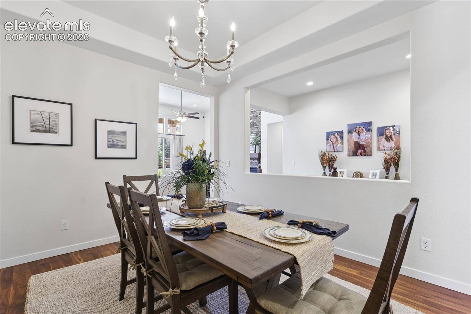 Dining area featuring a wood-finish floor and a crystal chandelier