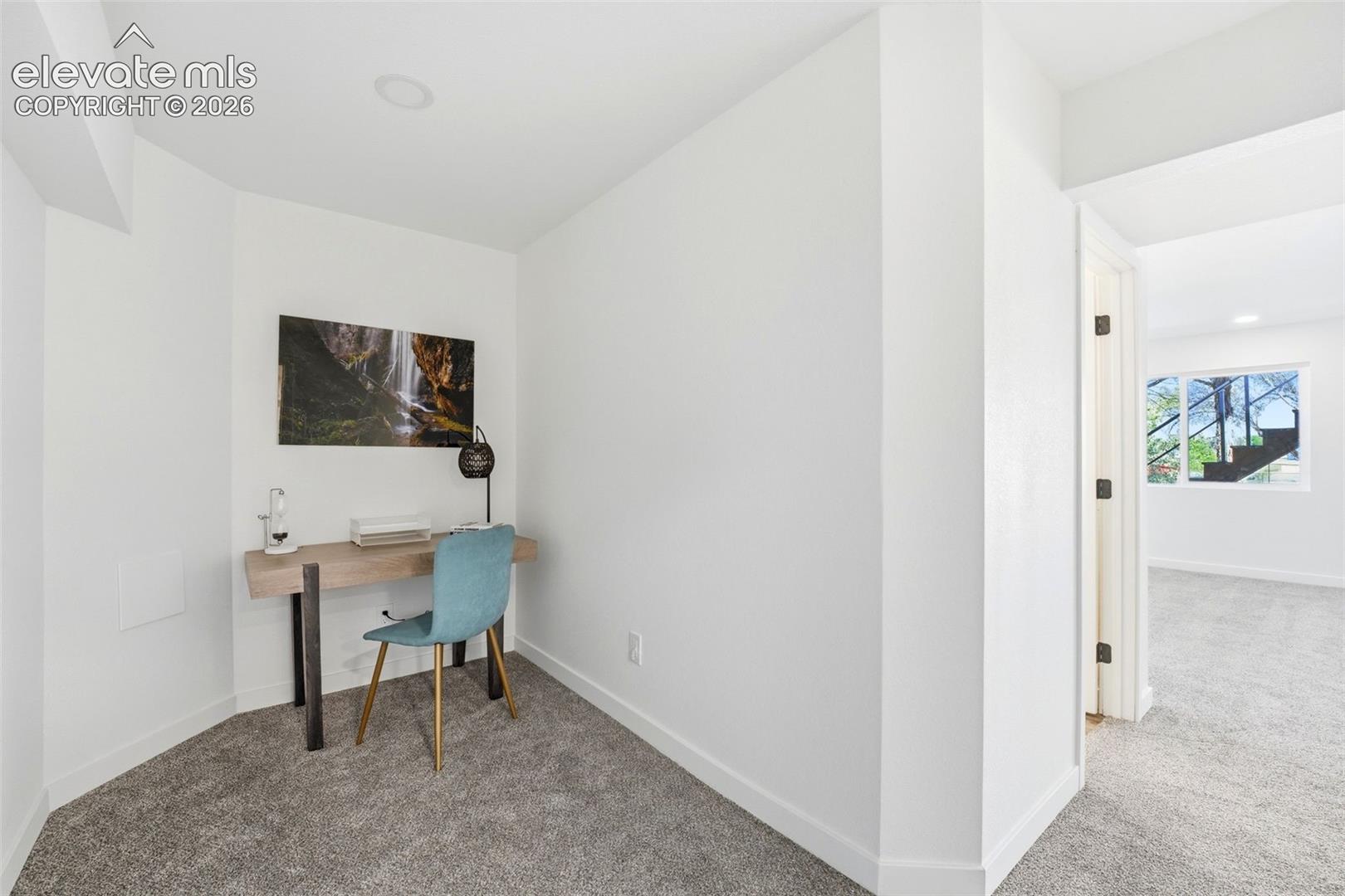 Dedicated alcove with recessed lighting, light gray carpet, and white baseboards