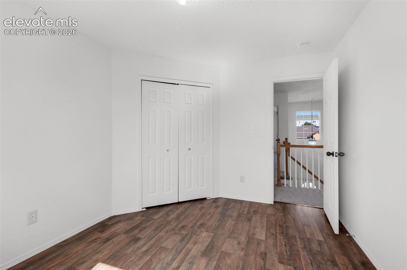 White walls with wood-finish flooring
