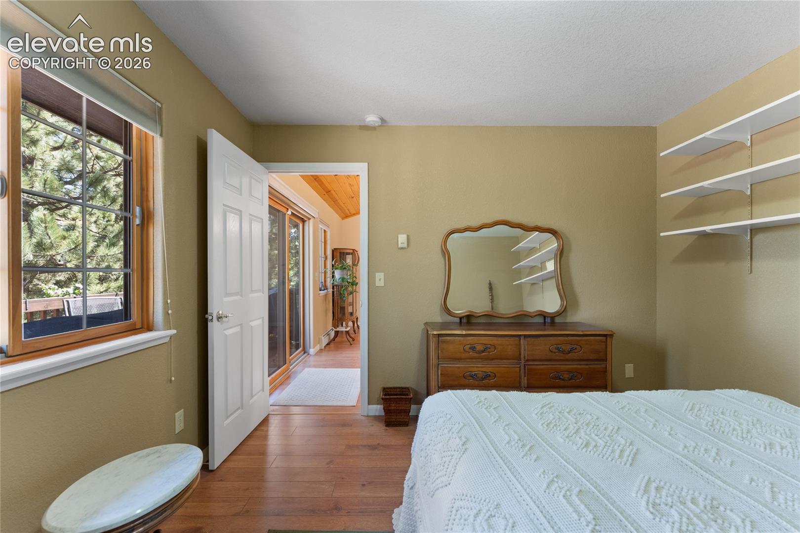 Warm-toned wall paint complements the wood-finish flooring