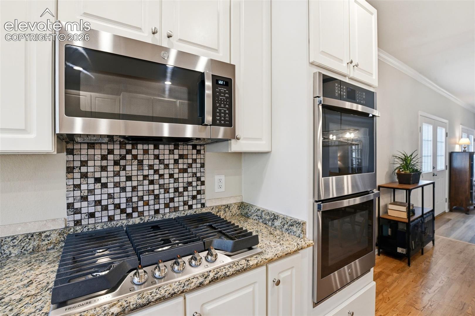 Custom tile backsplash and double wall ovens