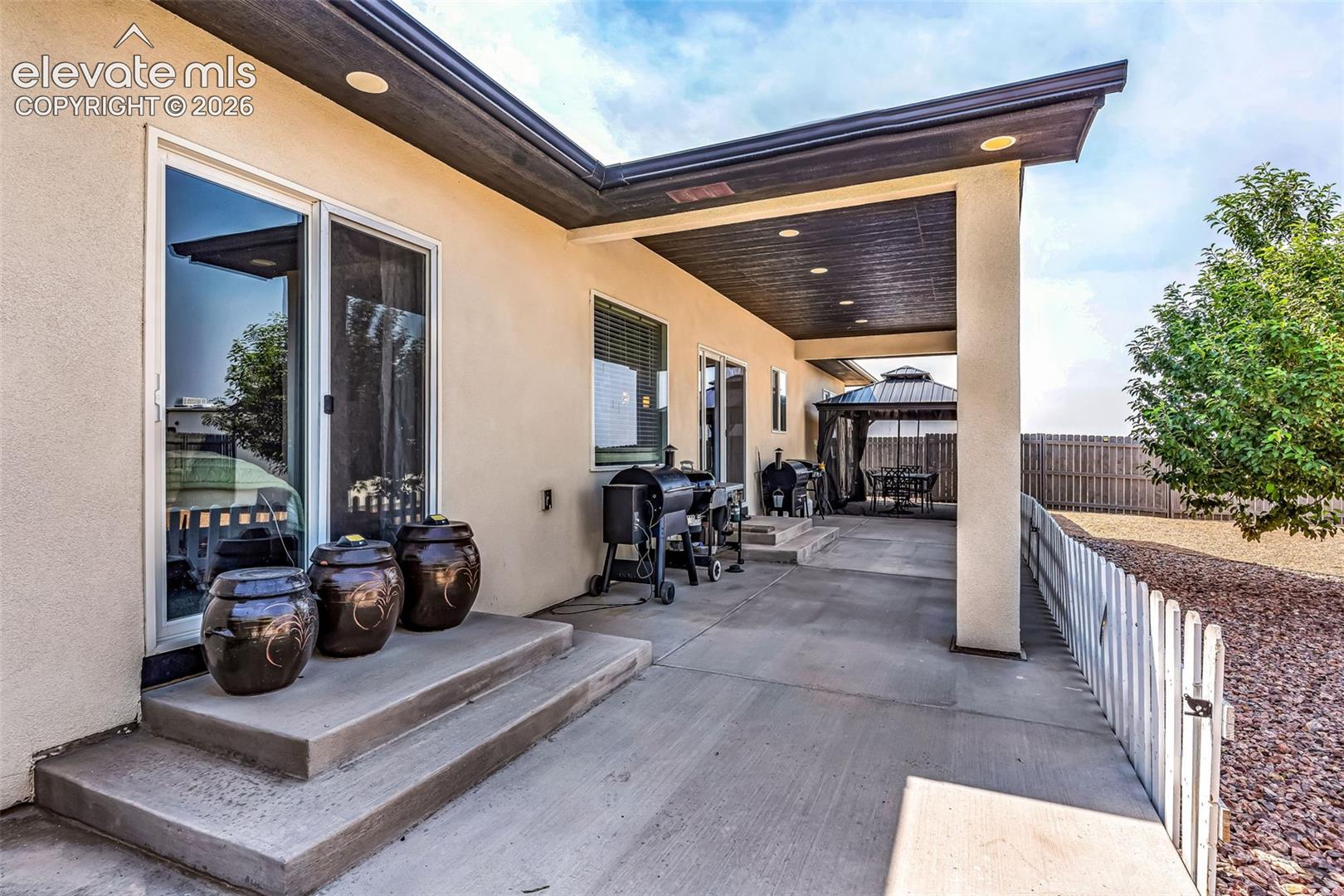 Spacious concrete patio with a covered outdoor living area