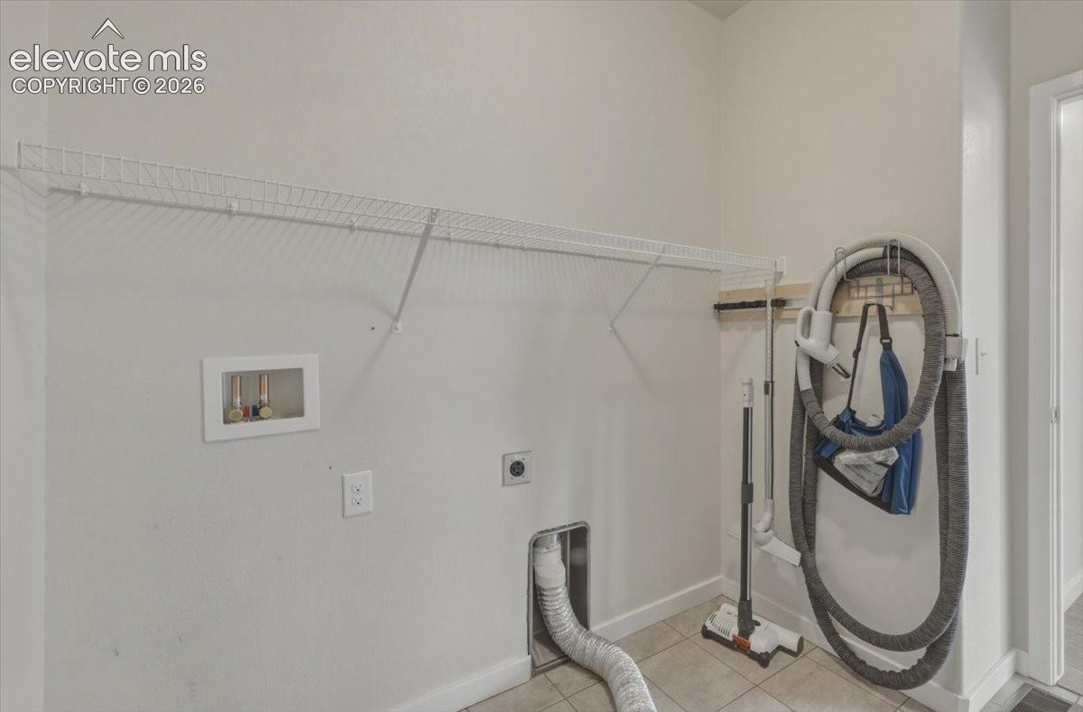 Utility area featuring central vacuum with organizer. 