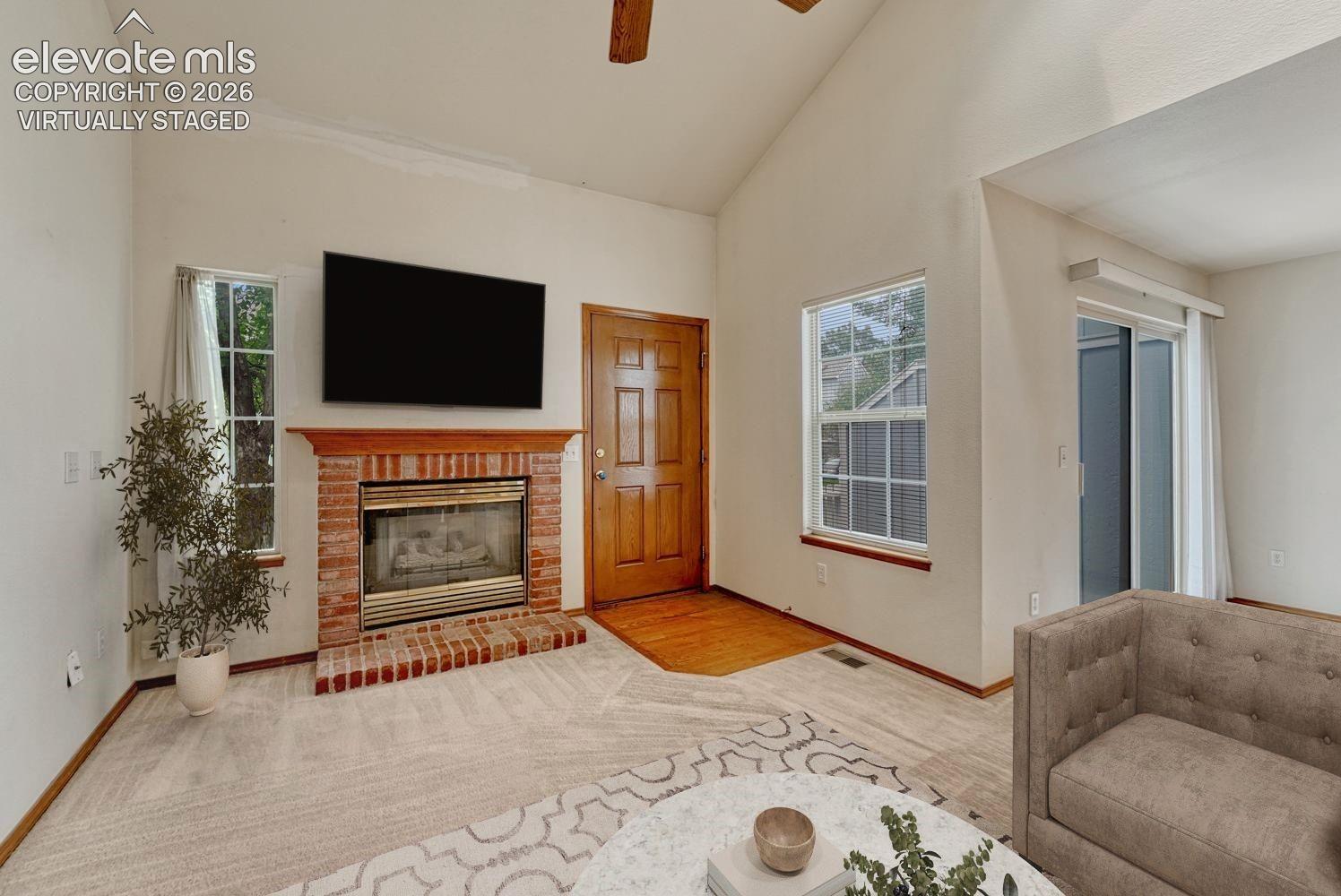 Brick fireplace accents the living room. Virtually staged.