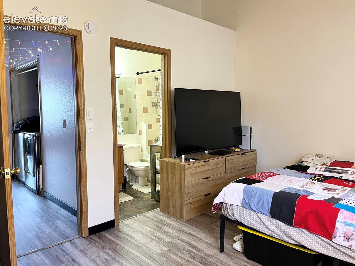 Neutral wall paint, light-toned wood-finish flooring, and natural wood-trim door frames