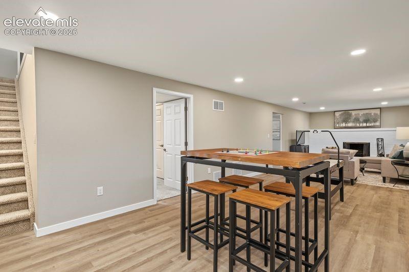Lower level rec room with recessed lighting.
