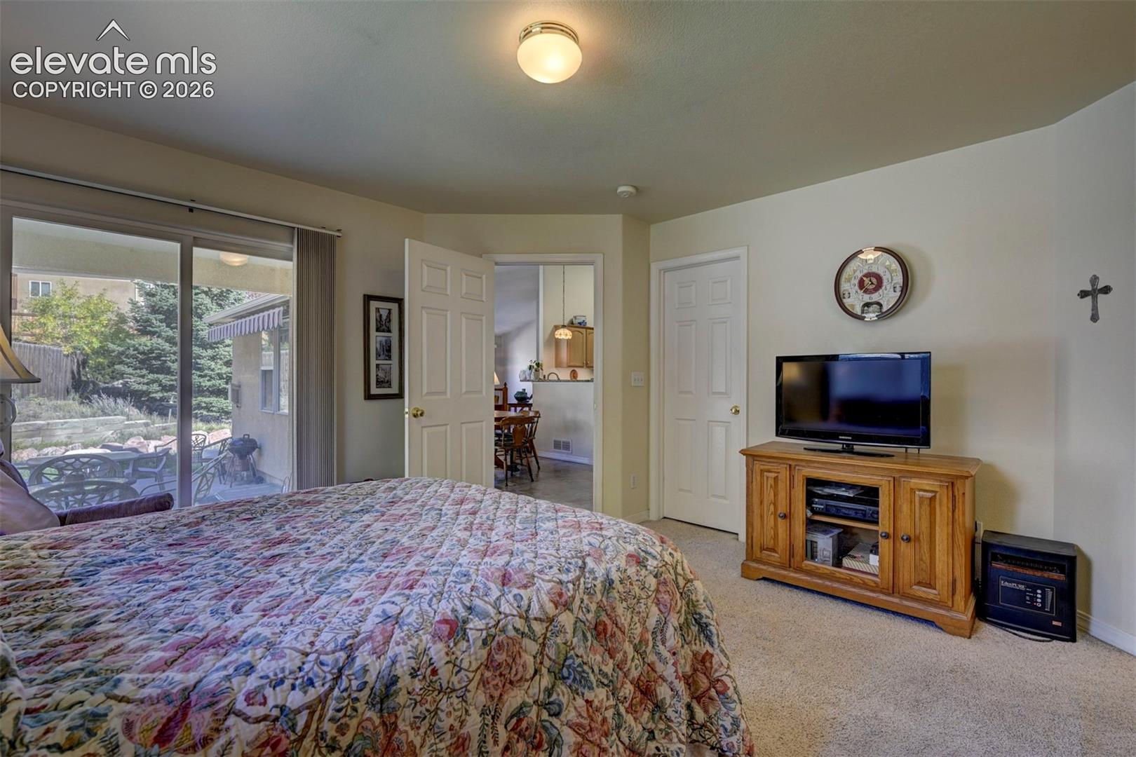 Primary Bedroom with Walk Out to Back Patio.