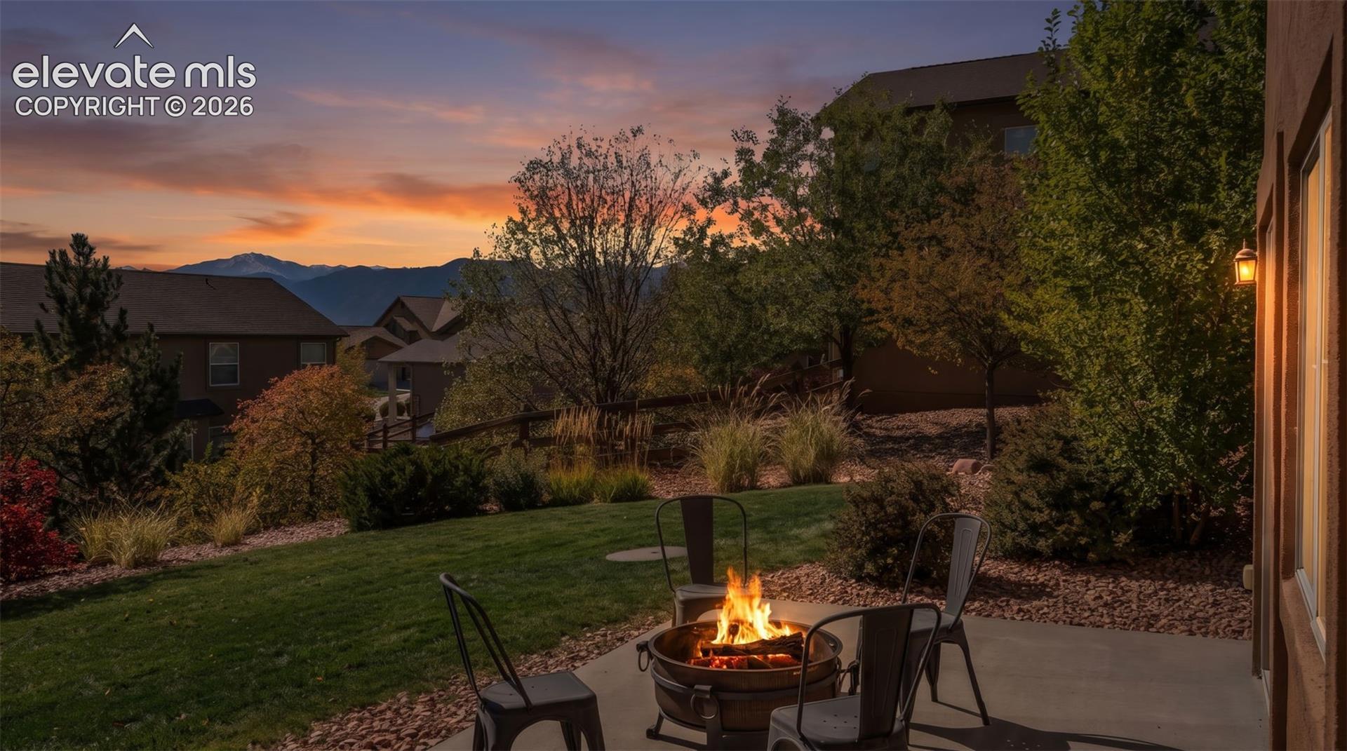 Concrete patio featuring a landscape of mature trees, shrubs, and mountain scenery