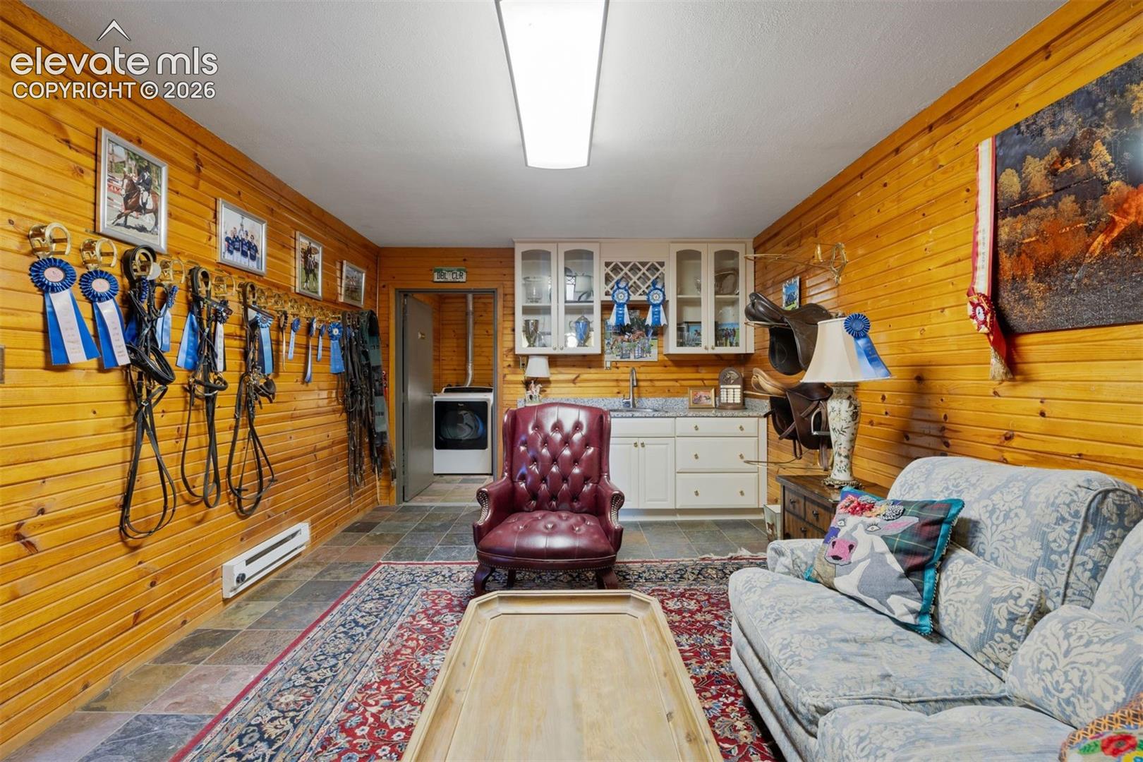 The barn has three tacks rooms, one with a lounge featuring a bathroom with laundry and a wet bar.