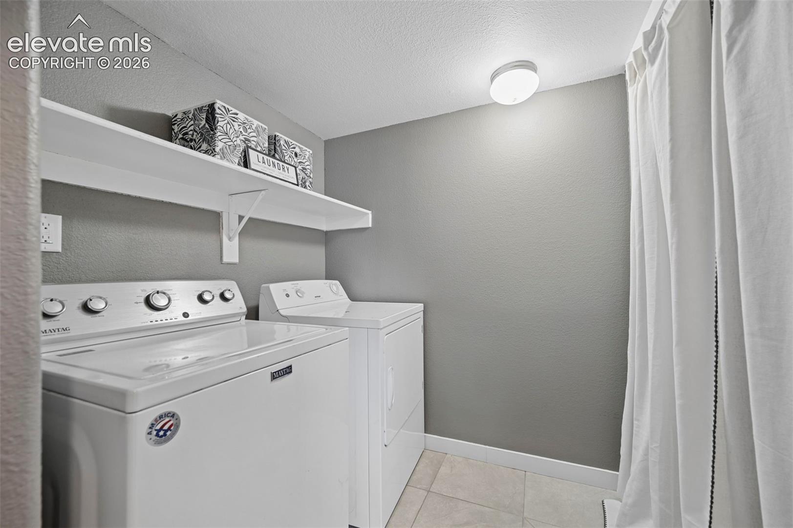 Laundry area with a white wall-mounted storage shelf