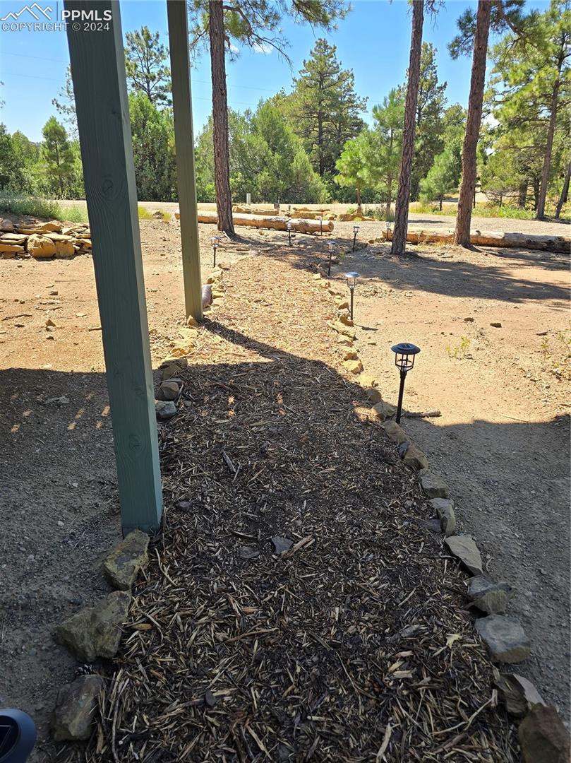 View of lighted pathway from front parking area to house. 