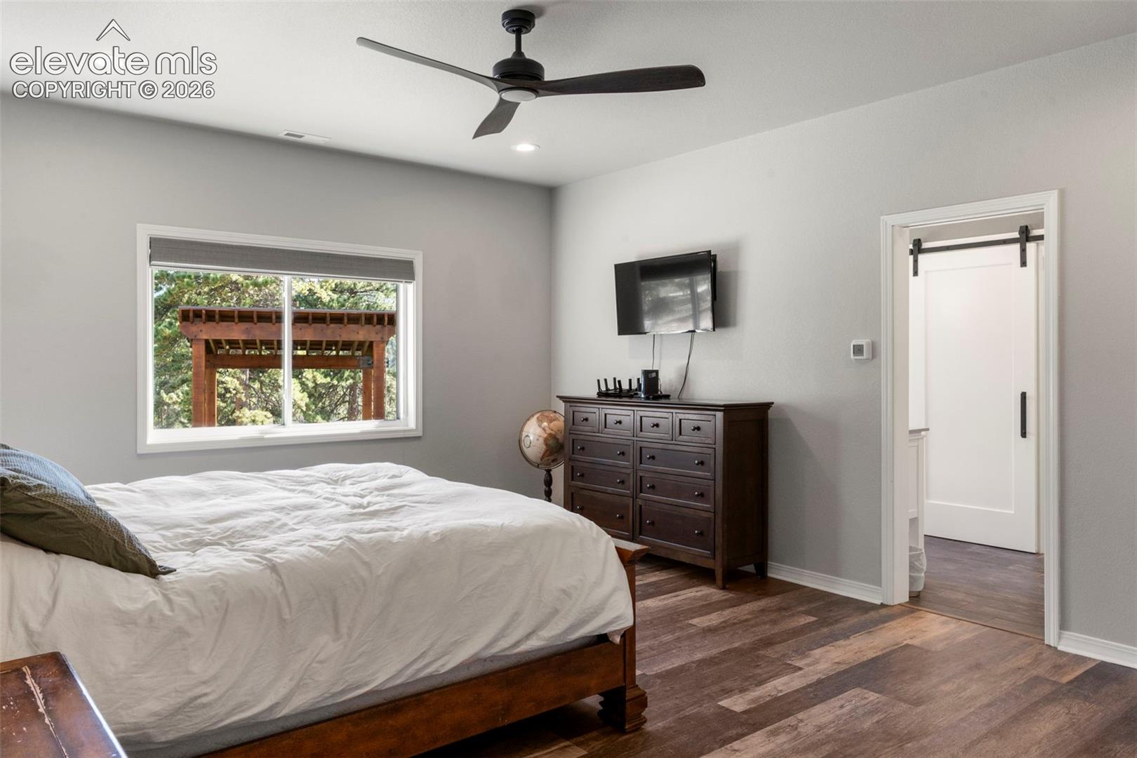 Bedroom with dark wood finished floors, ceiling fan, and recessed lighting