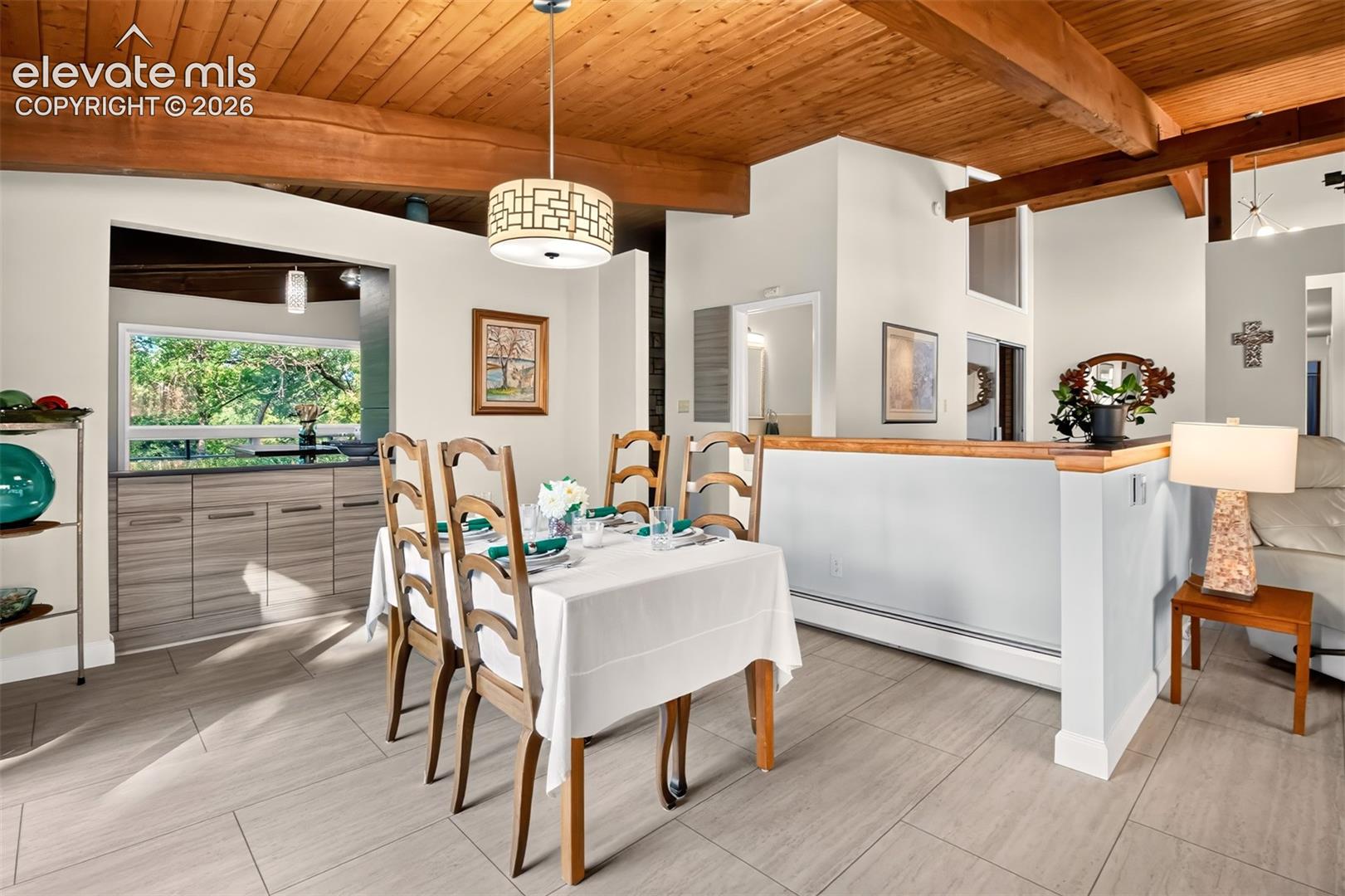The dining room can easily accommodate a long table. Note the buil-in cabinets for dish and linen storage.