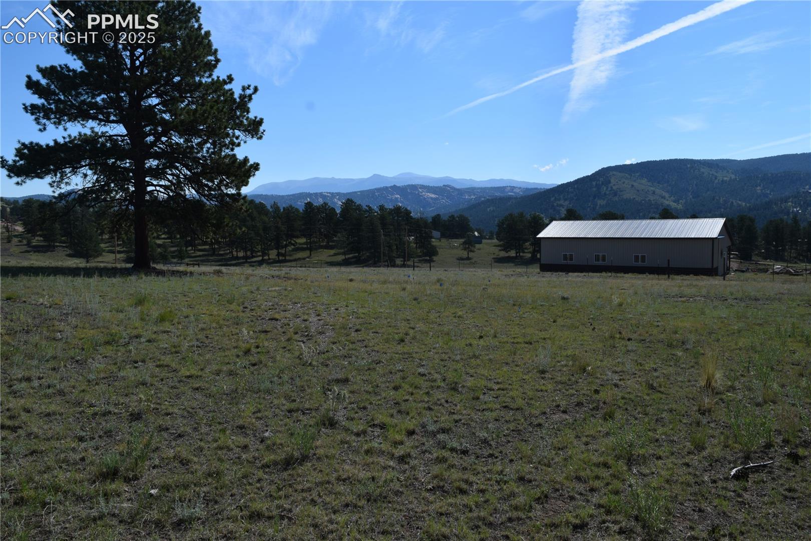 View of mountain backdrop featuring rural landscape