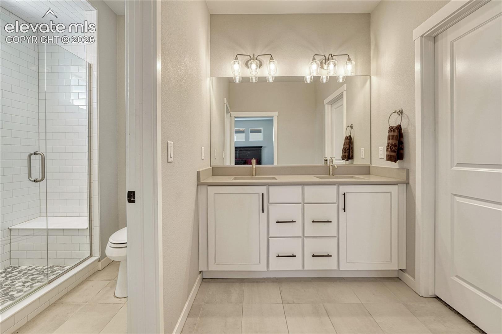 Primary bath with double vanity, walk-in closet...