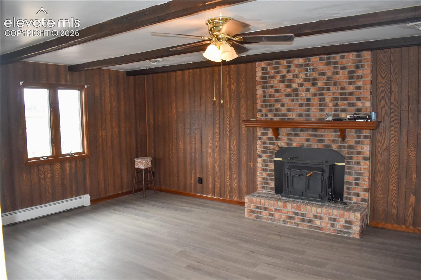 Brick fireplace with a wood-burning insert and mantel