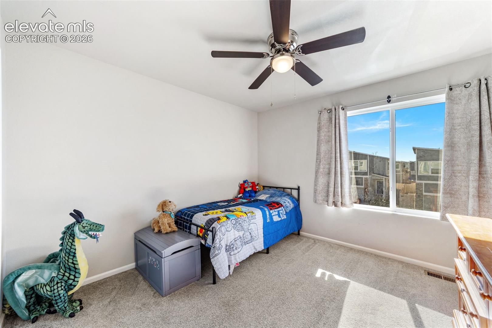 Third bedroom with large window and natural light.