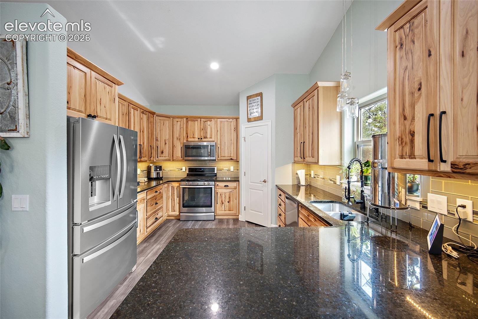 Kitchen with warm wood cabinetry and stainless appliances
