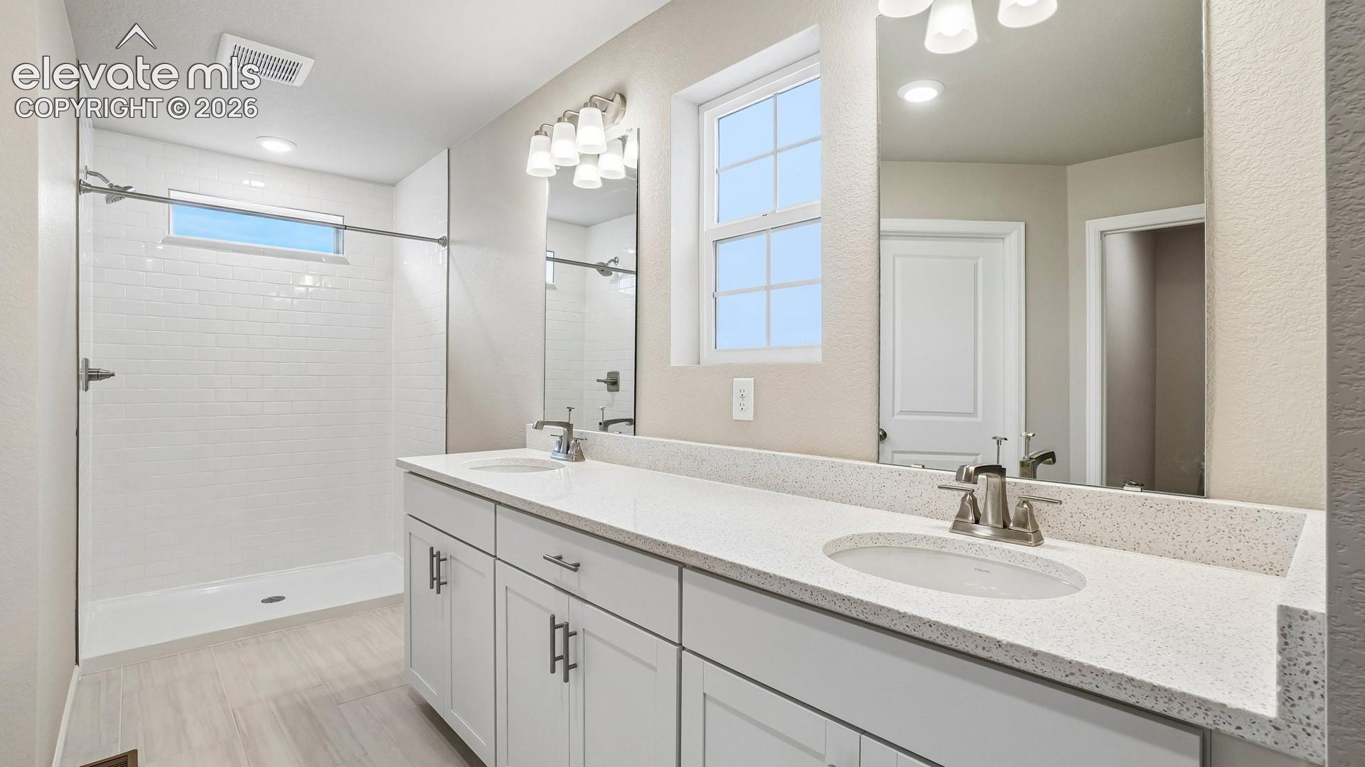 Dual vanity with integrated sinks and a speckled countertop
*photos of a model home*