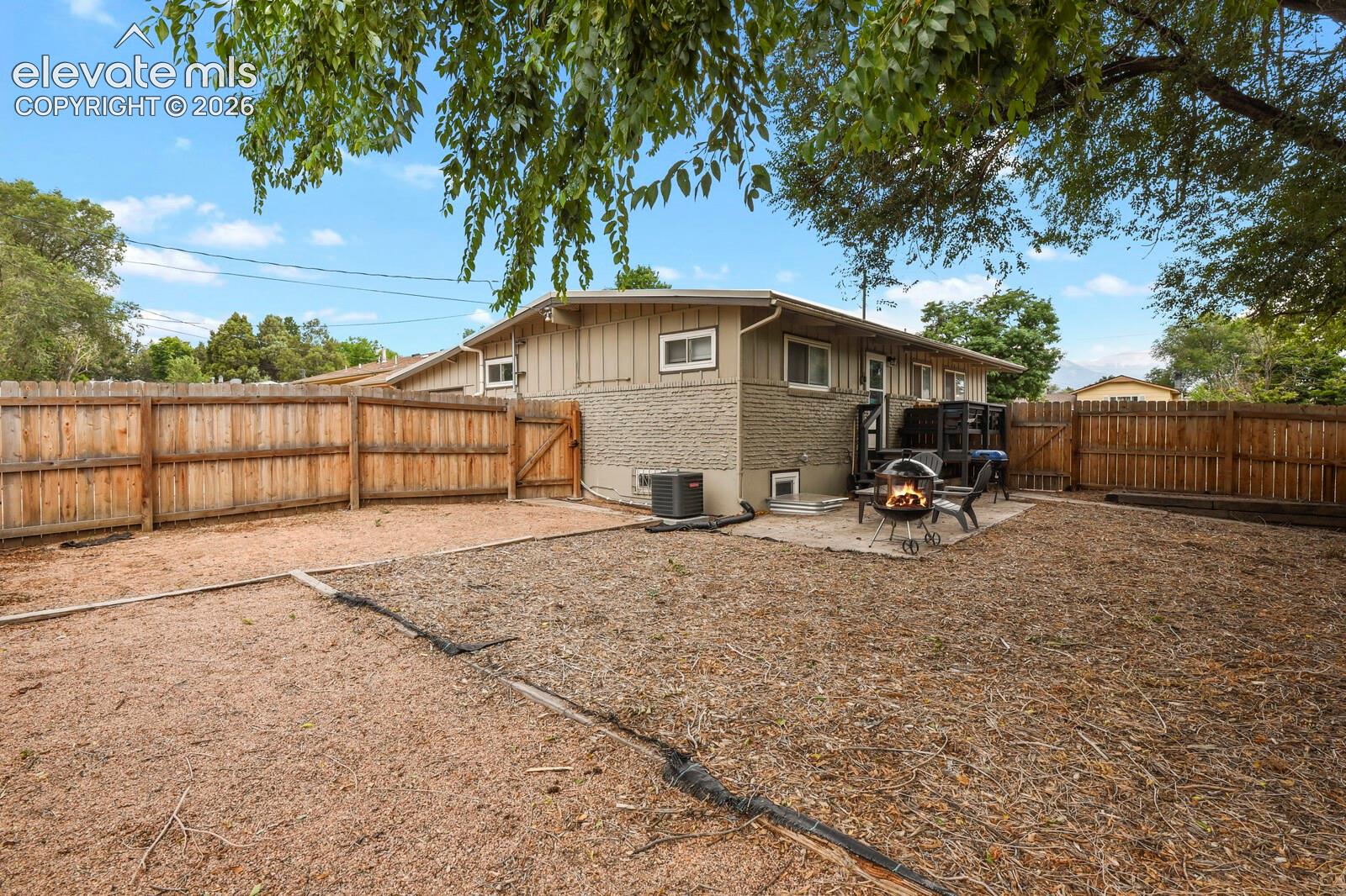 Picture of the backyard from the back corner of the fence.