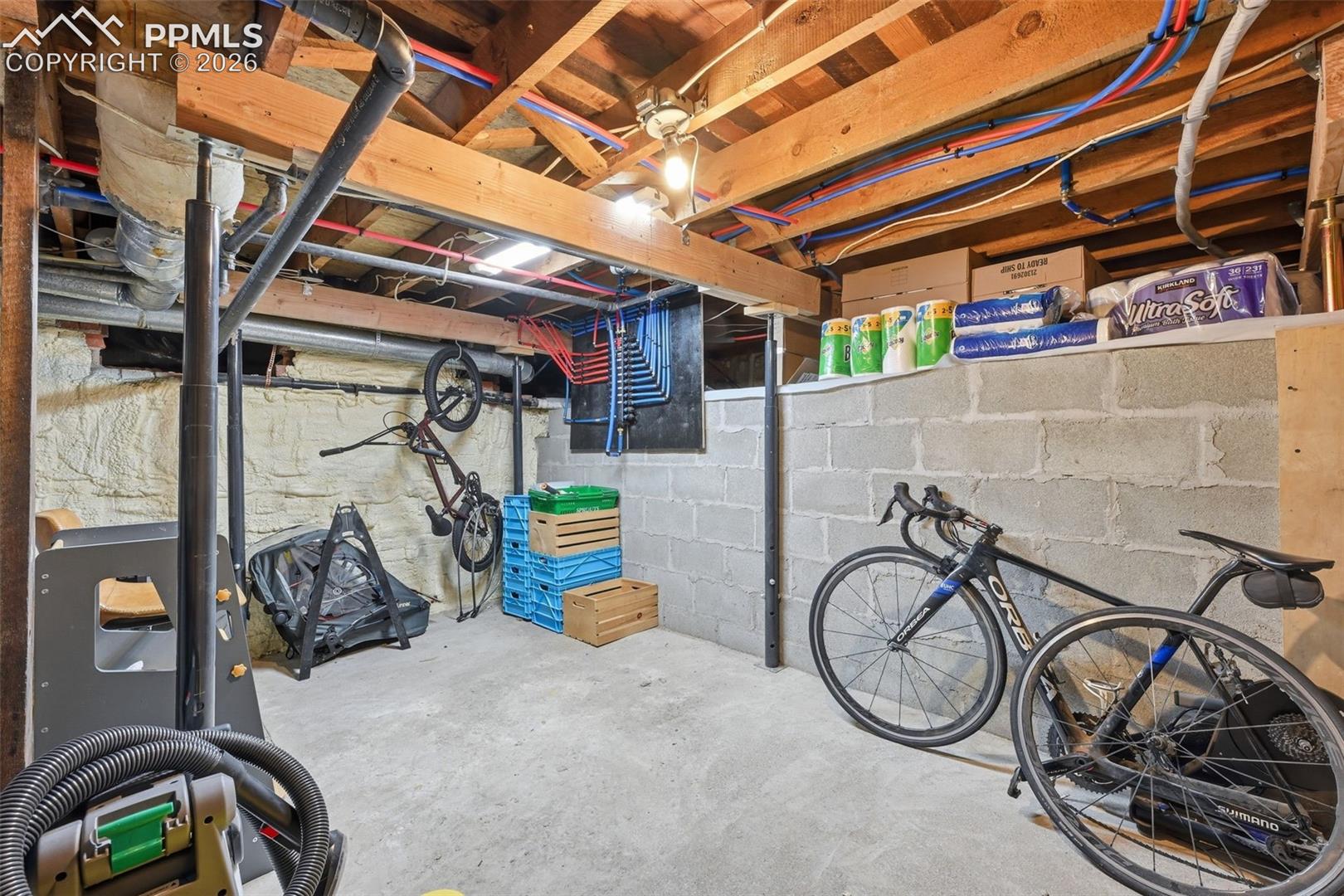 Unfinished basement / utility room offers ample room for storage.
