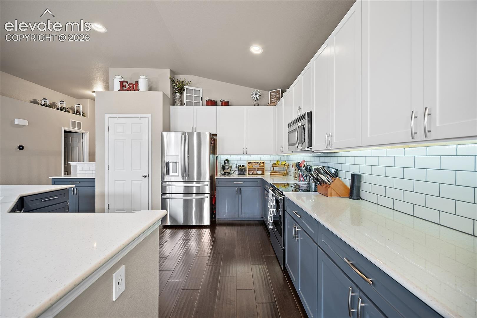 Updated kitchen cabinetry with pull-out storage.