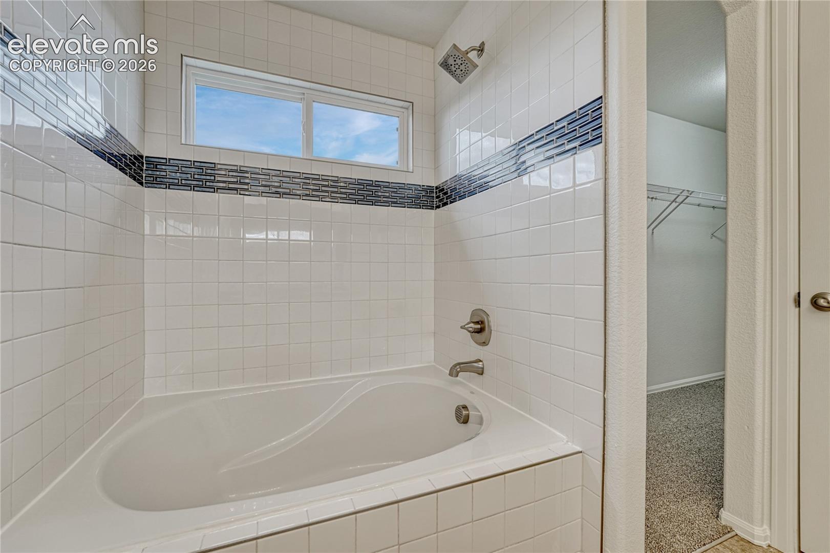 Primary bathroom has double vanity, soaker tub...