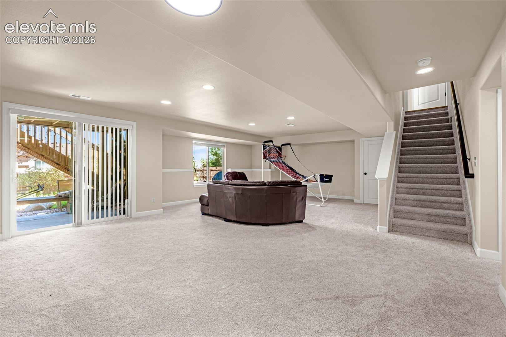 Walk-out family room has ample room for all needs.  Bright and open offering an inviting space for family and friends.  