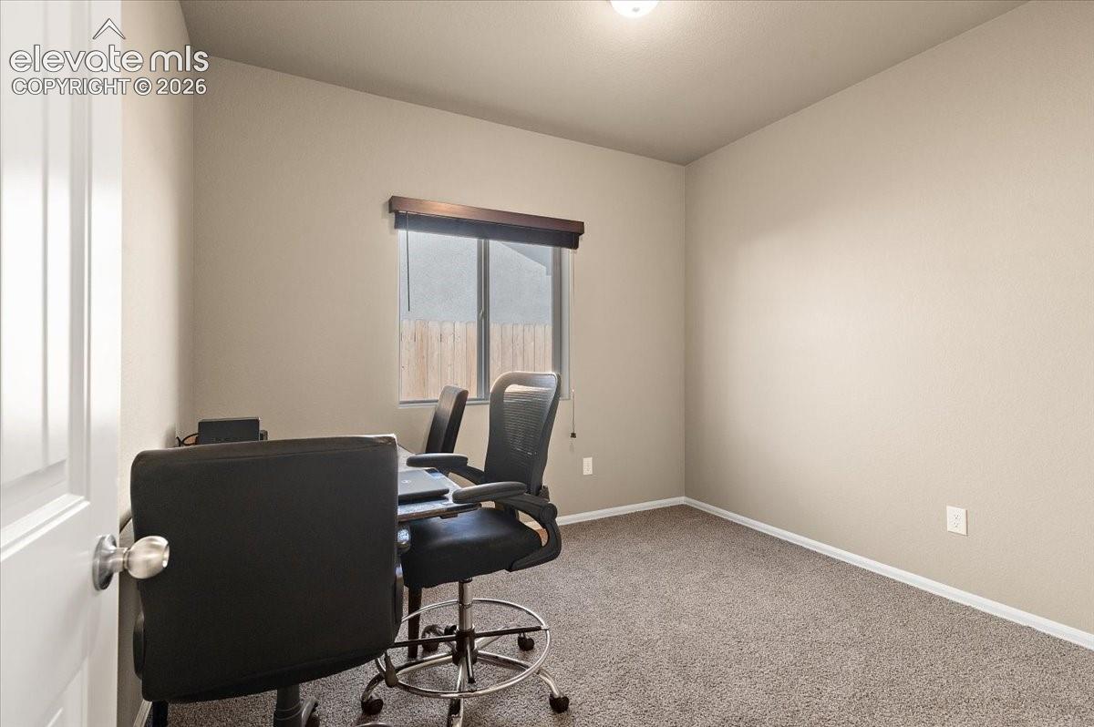 Neutral wall tones, carpeted flooring, a recessed window, and white trim